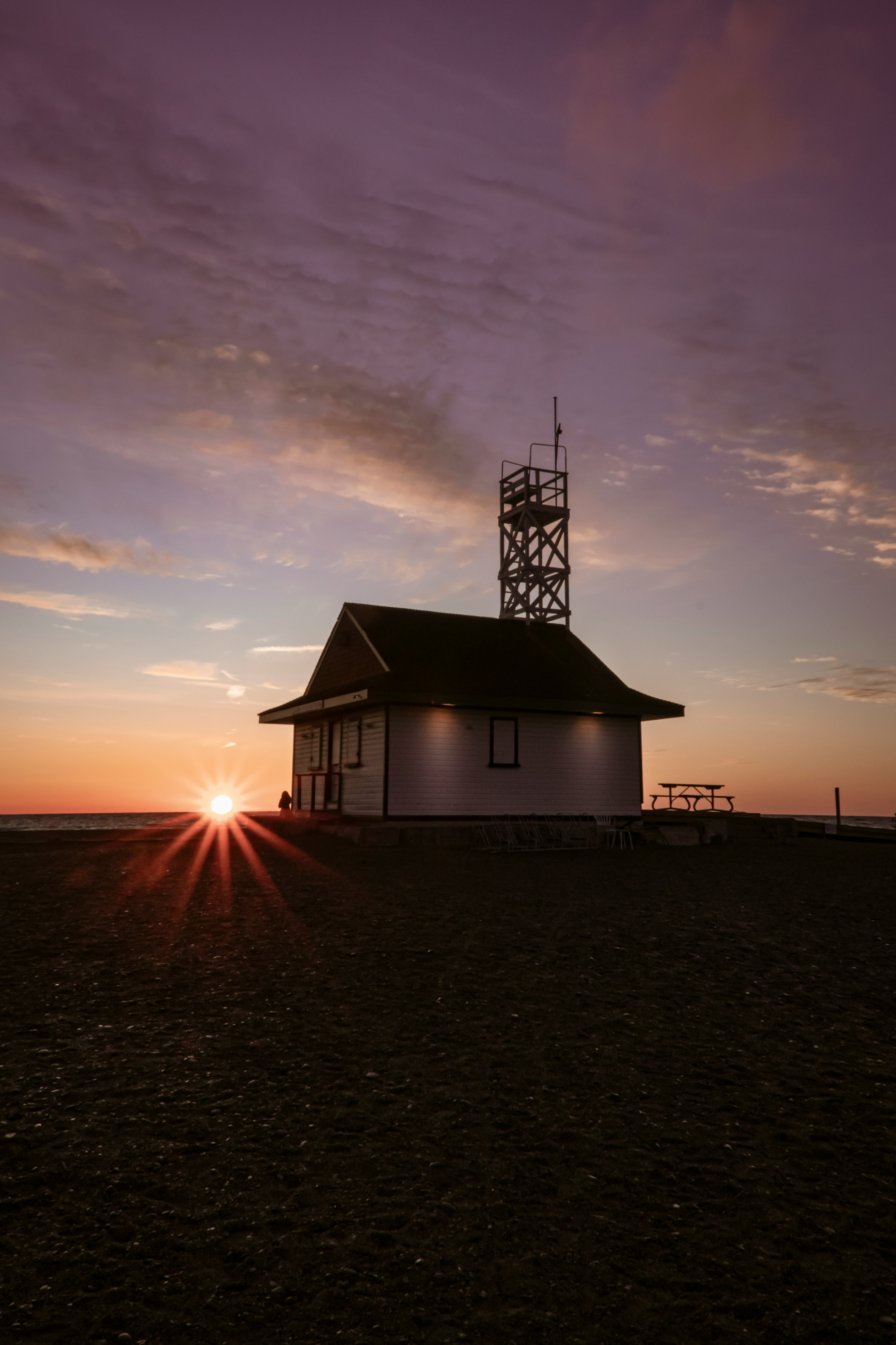 brown house with metal tower during golden hour